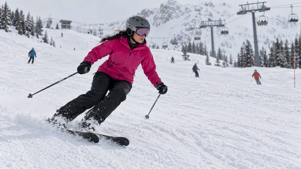 Woman skiing on a snowy mountain slope