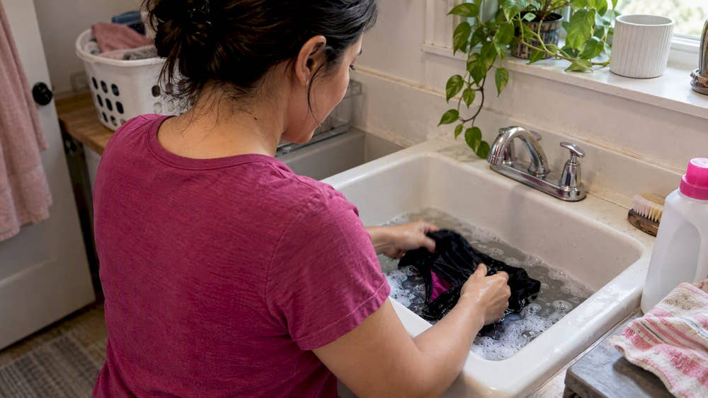 Woman soaking period underwear in a sink