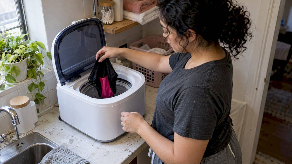 Period underwear placed loosely in mini washer