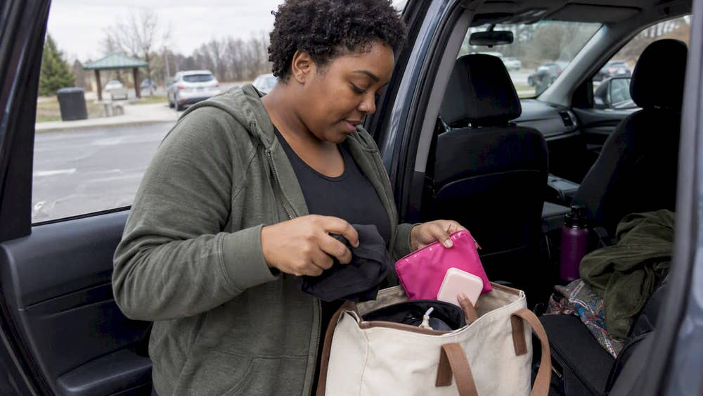 Traveler packs period supplies into a day bag