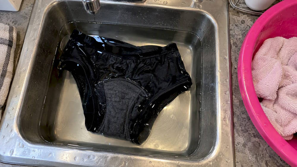 Period underwear soaking in a laundry sink