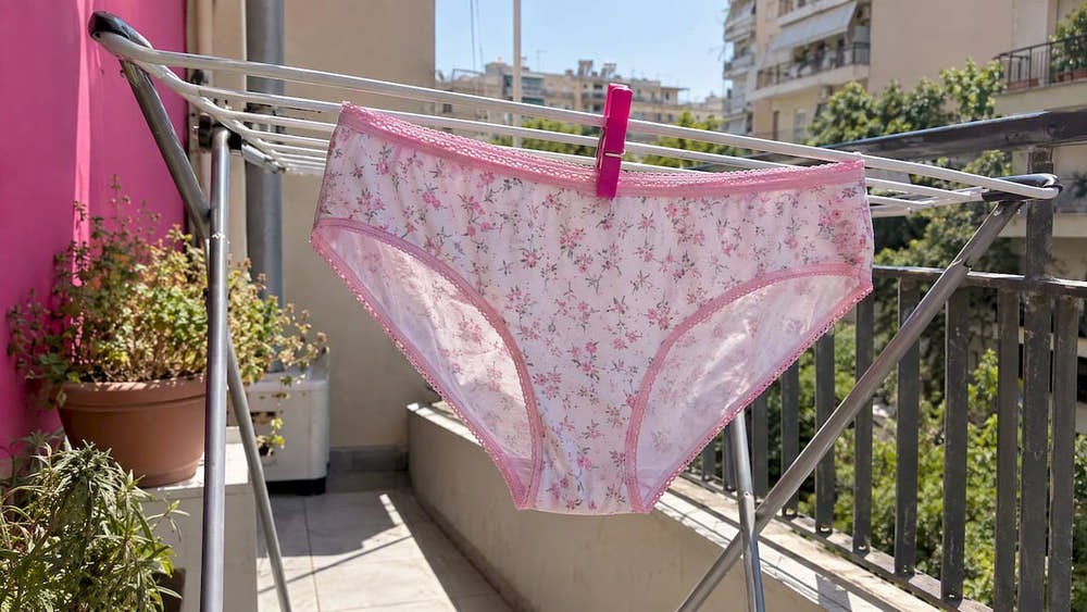 Underwear drying on a sunny apartment balcony