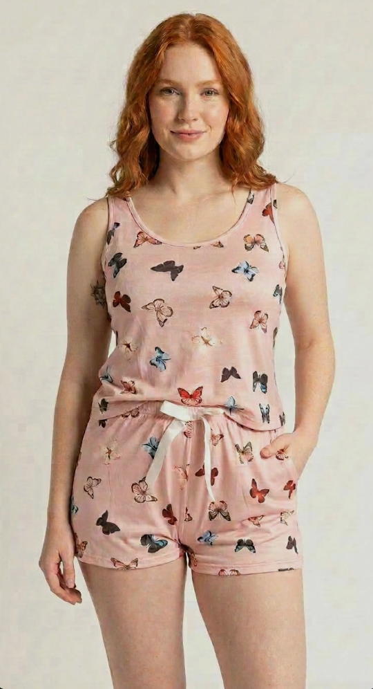 Model wearing SweeTee Rosie pink butterfly-print pajama tank and shorts set