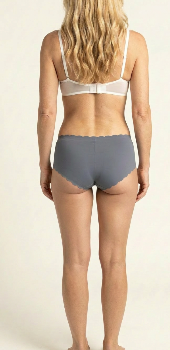 Model wearing SweeTee grey seamless scalloped cheekster period underwear, back view